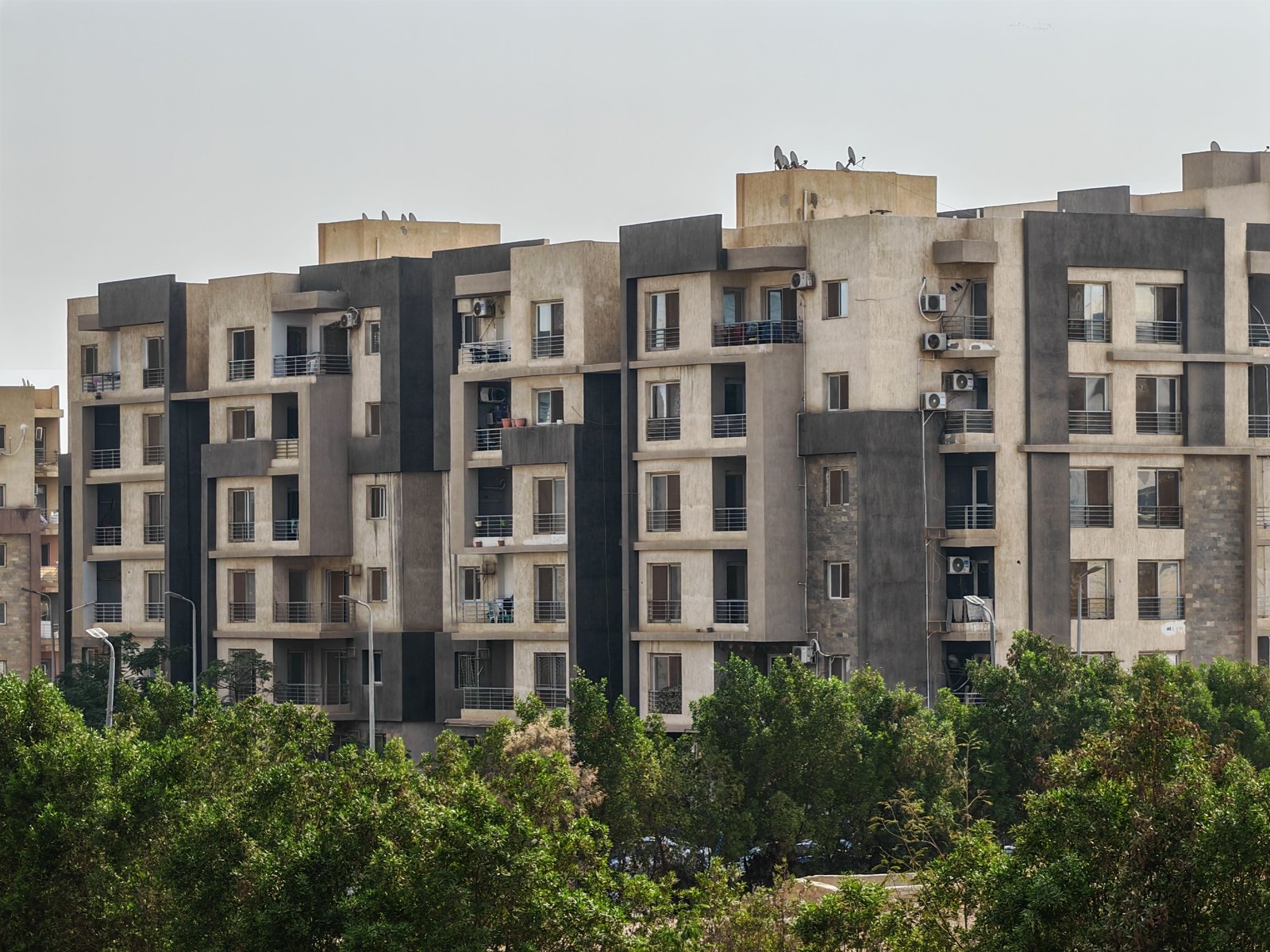 Apartment community exterior with balconies and landscaped grounds